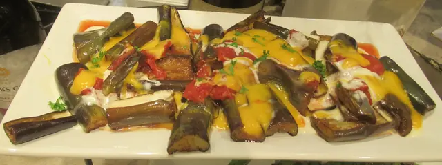 Finished Italian dish Eggplant Parmigiana served on a plate.